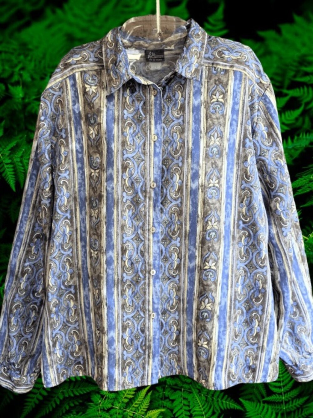 The image shows a blue and tan long-sleeve button-up shirt with a vertical, orna